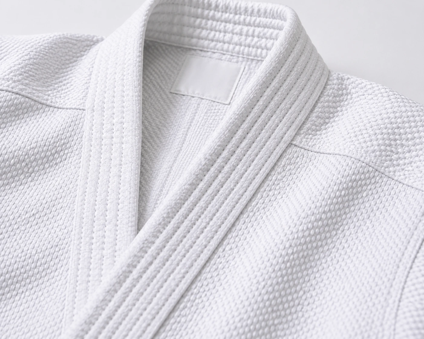 Close-up of white pearl weave karate gi fabric and reinforced collar