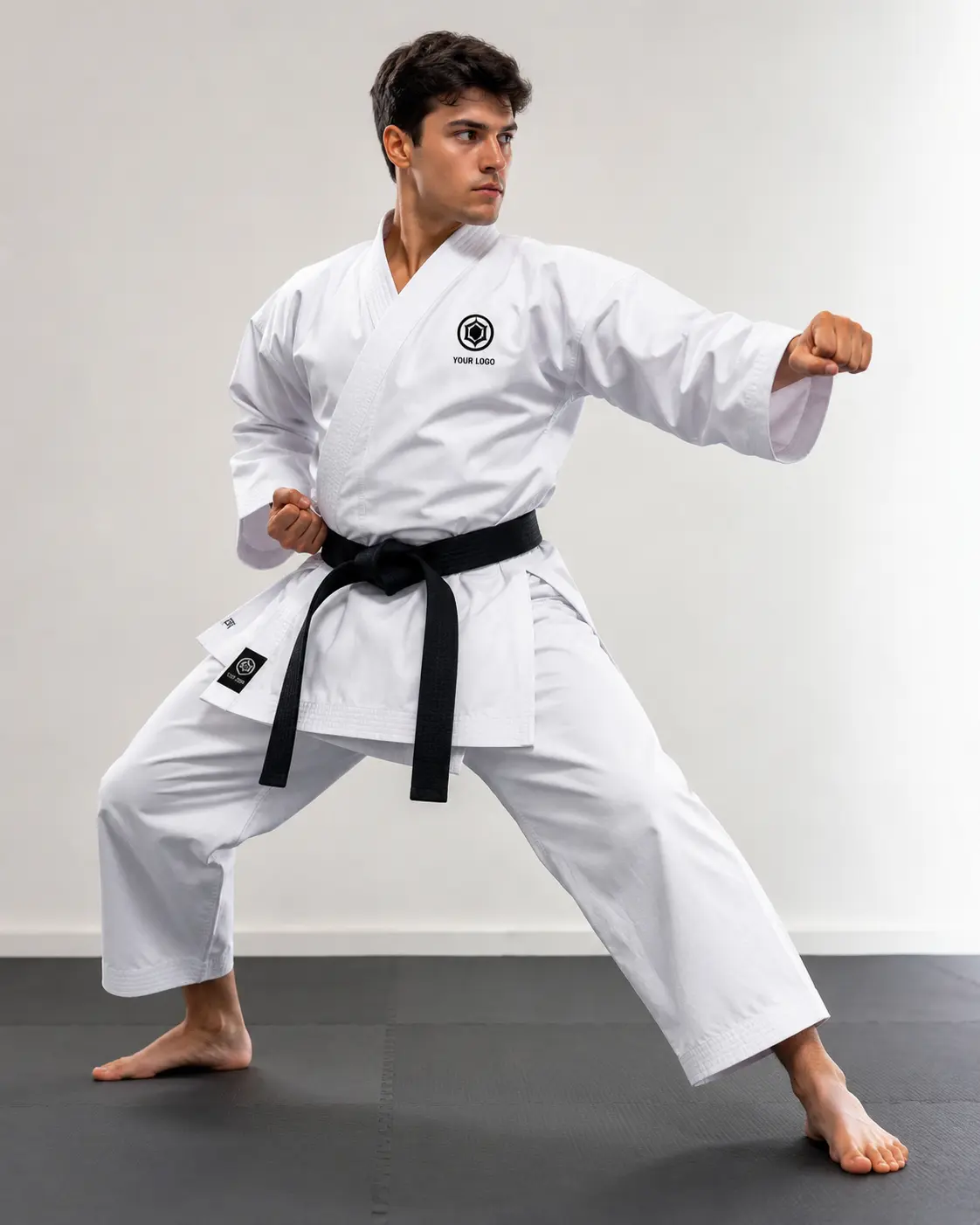 Martial artist wearing a custom white karate uniform with black belt